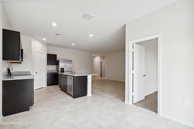 5516 E Mearn Rd, San Tan Valley, AZ 85140 - kitchen featuring stainless steel appliances, light countertops, light tile patterned flooring, an island with sink, and recessed lighting