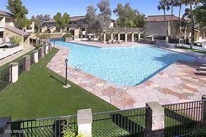 view of swimming pool featuring a patio and a lawn