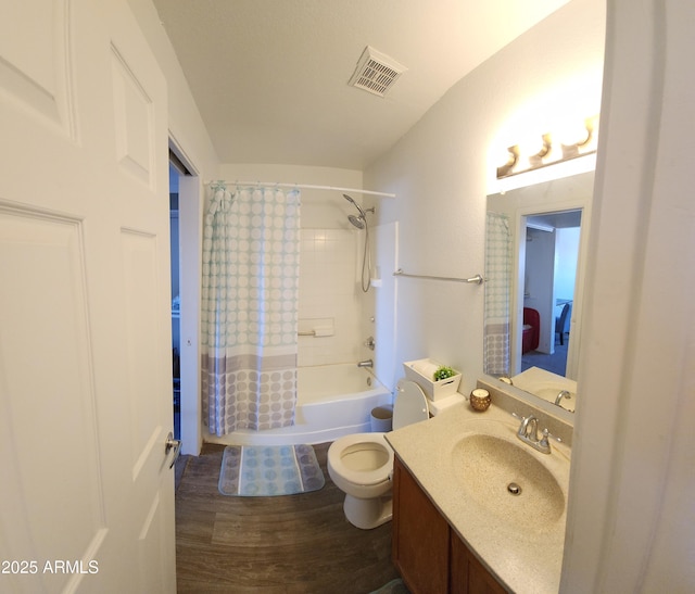 full bathroom with hardwood / wood-style floors, vanity, shower / bath combo, and toilet