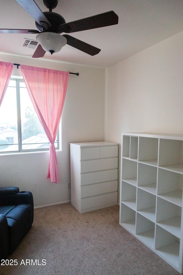 unfurnished room with ceiling fan and light colored carpet