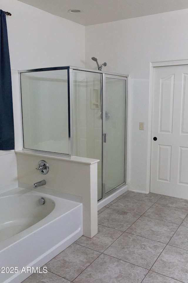 bathroom featuring tile patterned floors and shower with separate bathtub