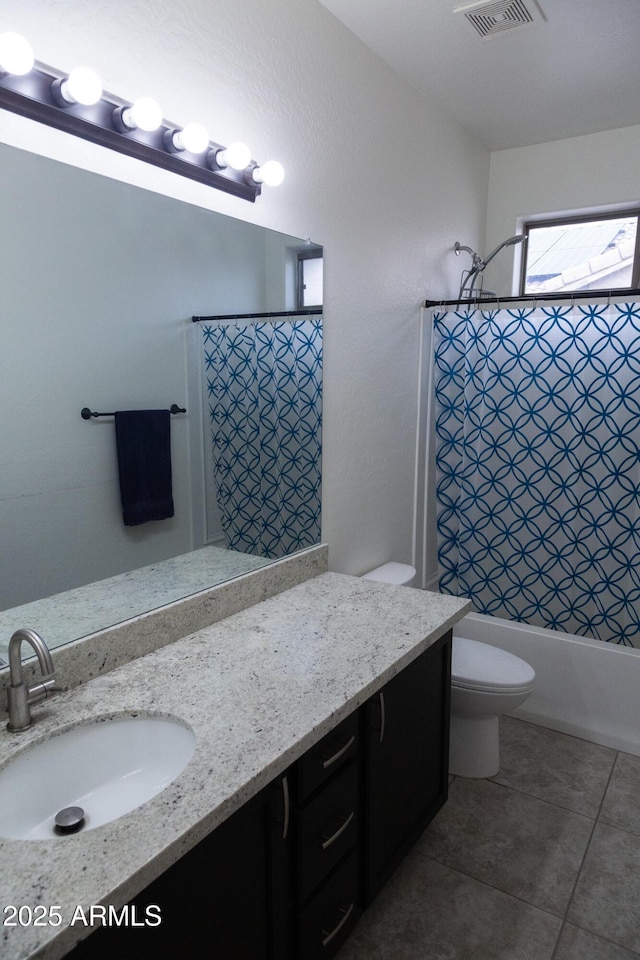 full bathroom featuring vanity, shower / tub combo, tile patterned flooring, and toilet