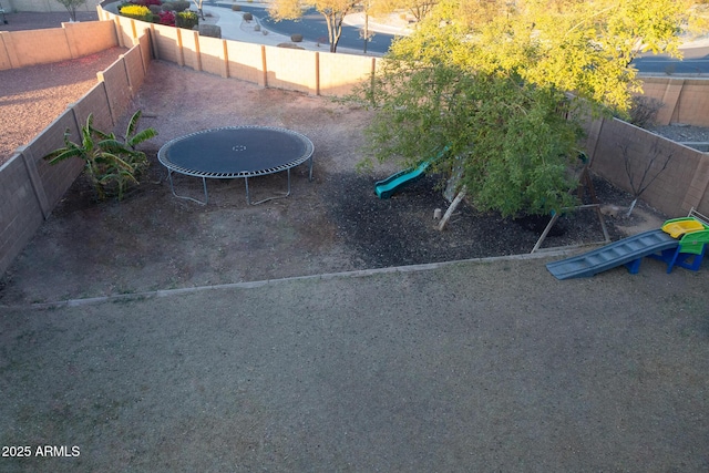 view of patio featuring a playground and a trampoline