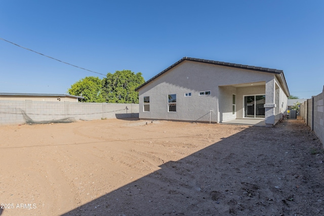 9310 W Washington St, Tolleson, AZ 85353 - rear view of house featuring a fenced backyard, a patio area, stucco siding, and central AC