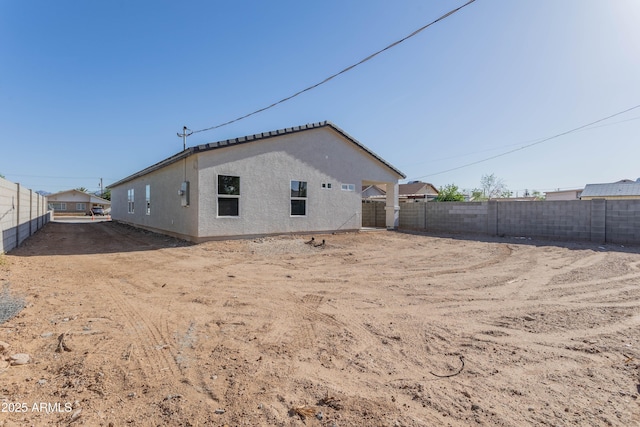 9310 W Washington St, Tolleson, AZ 85353 - rear view of house with a fenced backyard and stucco siding