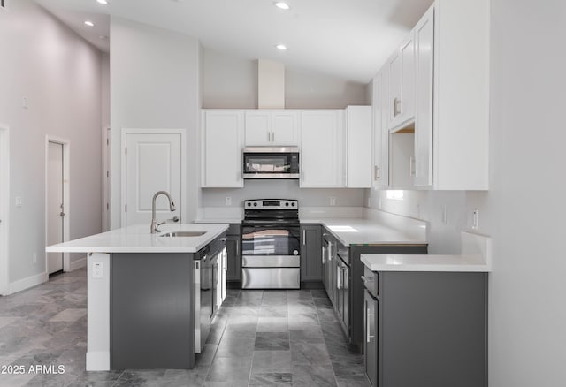 9310 W Washington St, Tolleson, AZ 85353 - kitchen featuring appliances with stainless steel finishes, a sink, high vaulted ceiling, white cabinets, and recessed lighting