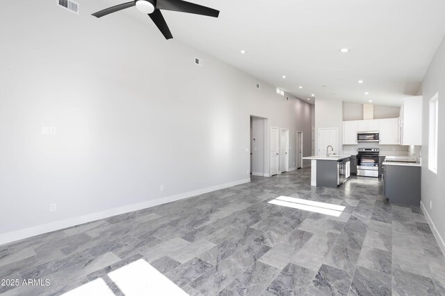 9310 W Washington St, Tolleson, AZ 85353 - kitchen featuring stainless steel appliances, a sink, white cabinets, a kitchen island with sink, and light countertops