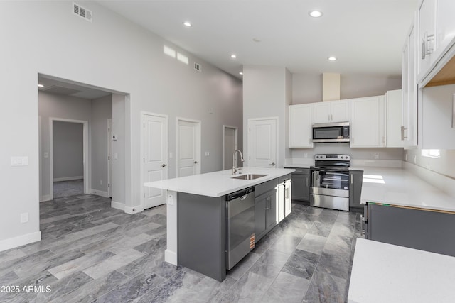 9310 W Washington St, Tolleson, AZ 85353 - kitchen featuring appliances with stainless steel finishes, a sink, high vaulted ceiling, light countertops, and a kitchen island with sink