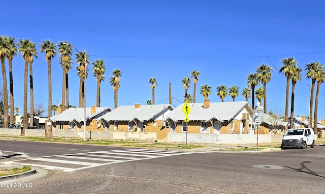 view of street with sidewalks, curbs, and a residential view