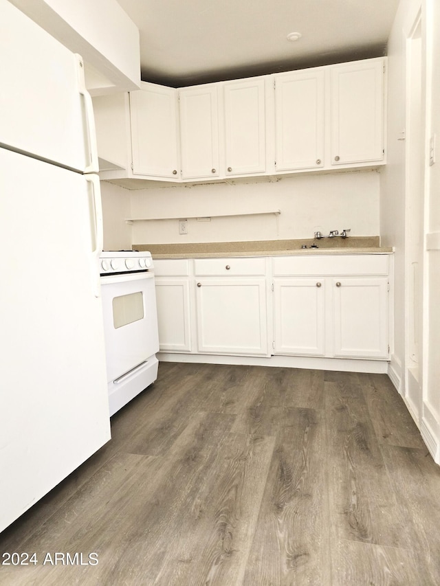 kitchen with dark wood-style floors, white appliances, white cabinets, and light countertops