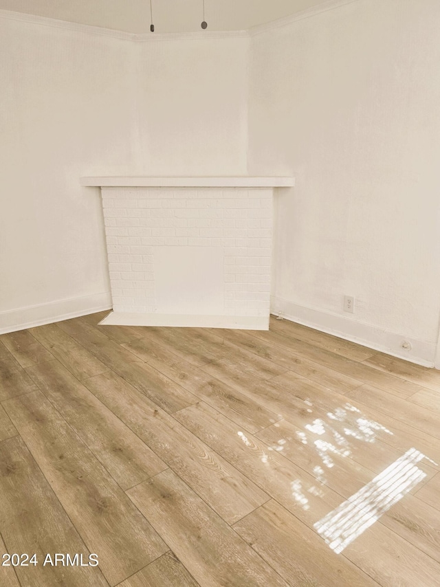 unfurnished living room with baseboards and wood-type flooring