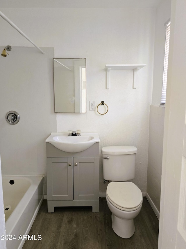 full bathroom featuring toilet, wood finished floors, and vanity