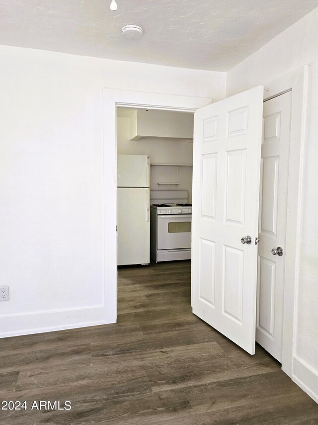 corridor with dark wood-style floors