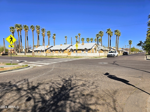 view of road with a residential view, curbs, and traffic signs