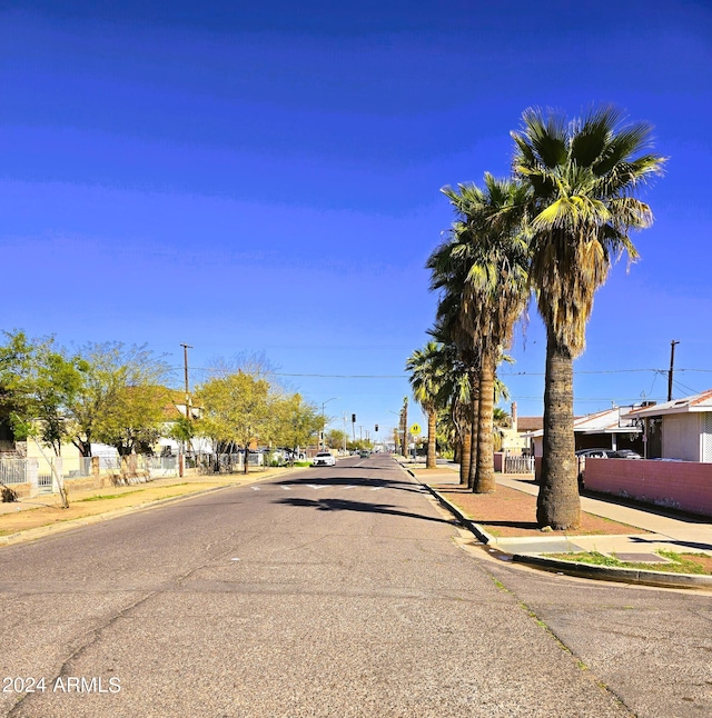 view of street featuring curbs, street lights, and sidewalks