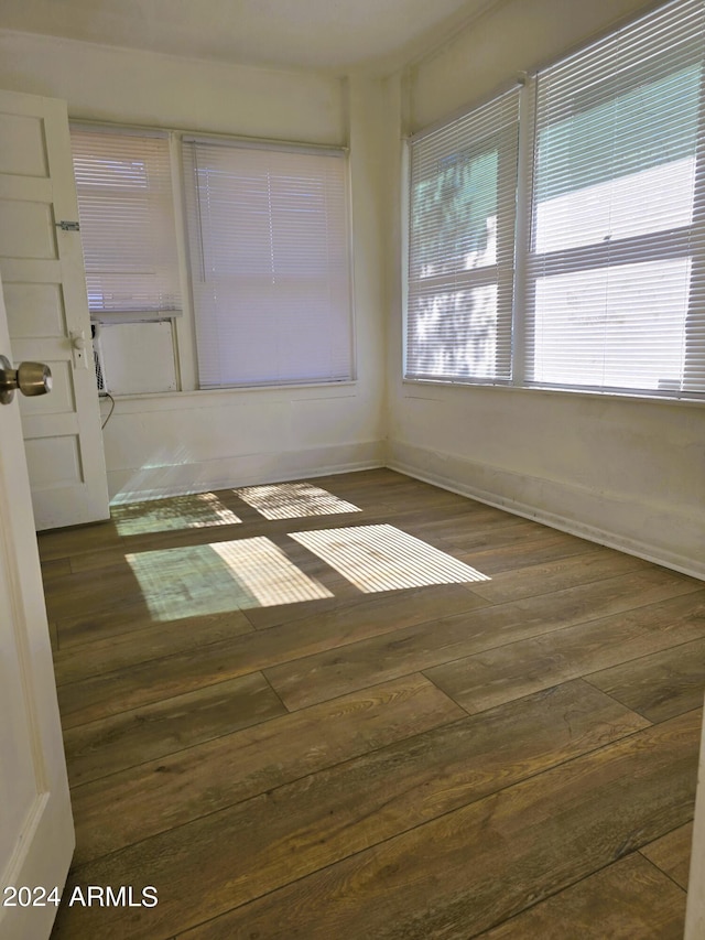 spare room with dark wood-style floors and baseboards