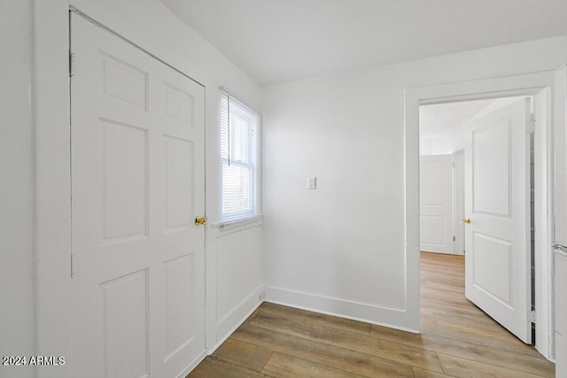 entrance foyer with baseboards and wood finished floors