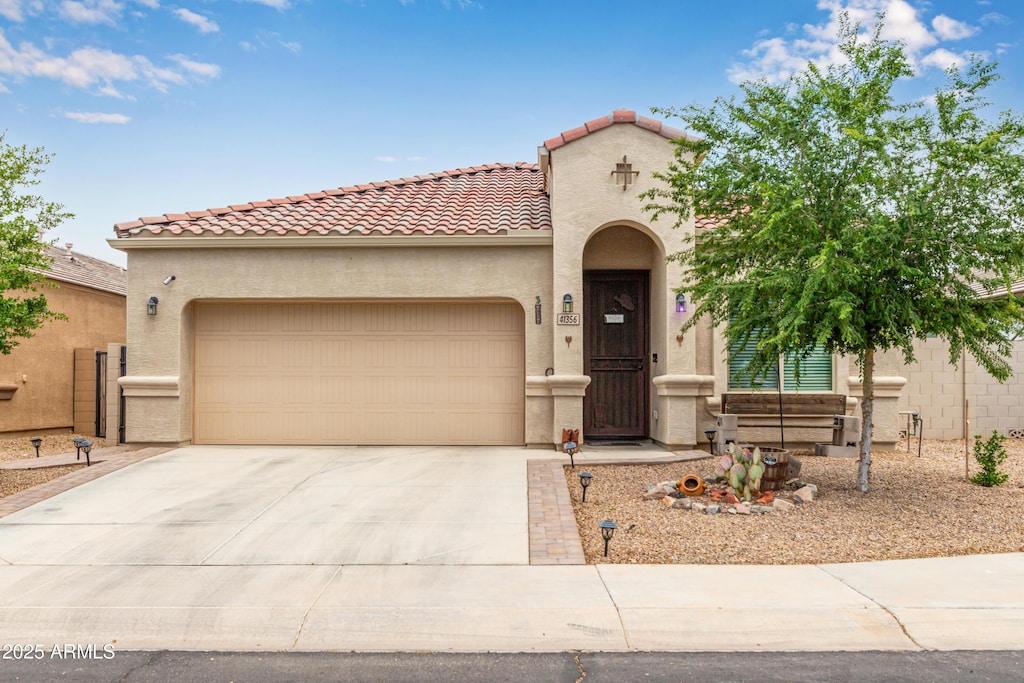 mediterranean / spanish-style home with a garage