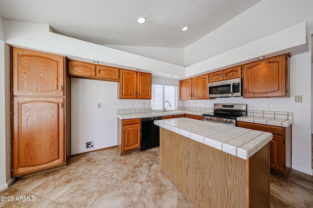 kitchen featuring a sink, a kitchen island, stainless steel appliances, tile counters, and vaulted ceiling