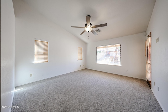 carpeted empty room featuring a ceiling fan, visible vents, and high vaulted ceiling