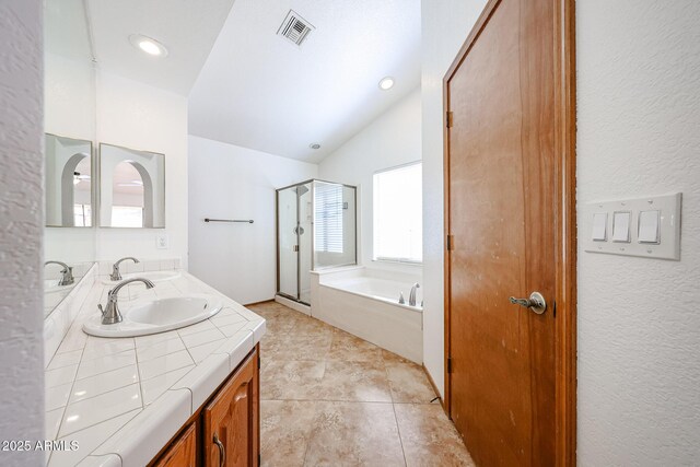 full bath with visible vents, a garden tub, a stall shower, double vanity, and lofted ceiling