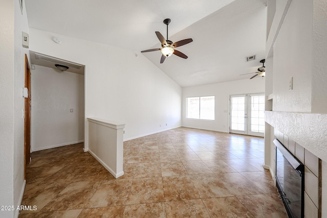 unfurnished living room with visible vents, a ceiling fan, a tile fireplace, wine cooler, and vaulted ceiling