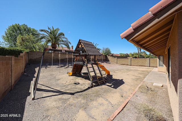 view of yard with a fenced backyard and a playground