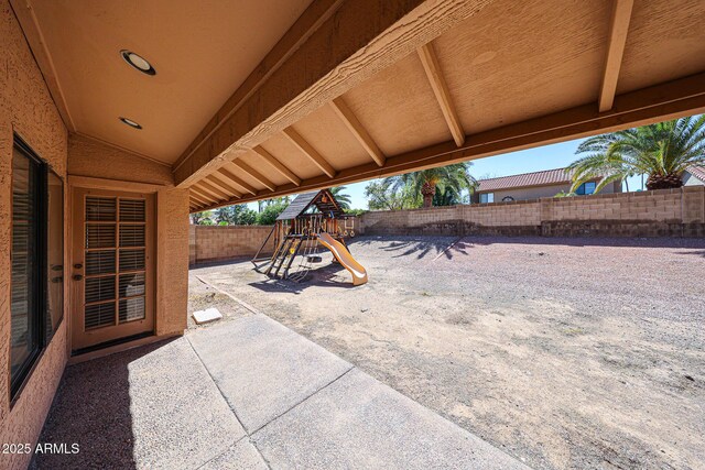 view of patio / terrace with a playground and a fenced backyard