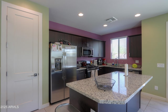 17743 N Rosa Dr, Maricopa, AZ 85138 - kitchen with visible vents, appliances with stainless steel finishes, a sink, a center island, and light tile patterned floors