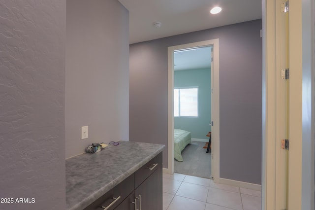 17743 N Rosa Dr, Maricopa, AZ 85138 - ensuite bathroom with connected bathroom, vanity, tile patterned flooring, baseboards, and a textured wall