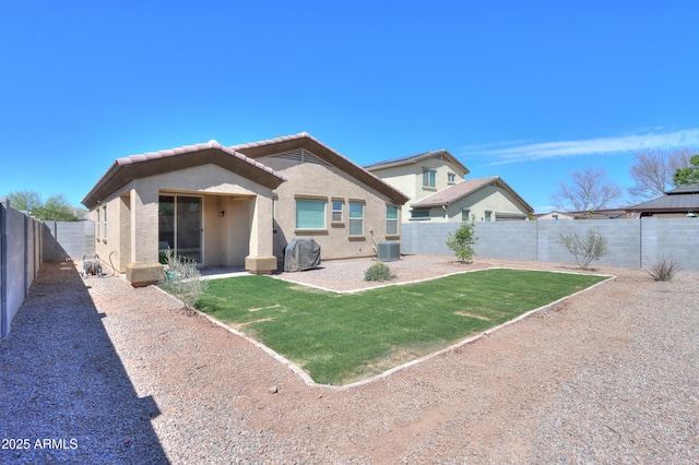 17743 N Rosa Dr, Maricopa, AZ 85138 - back of house featuring a fenced backyard, a tile roof, stucco siding, cooling unit, and a yard