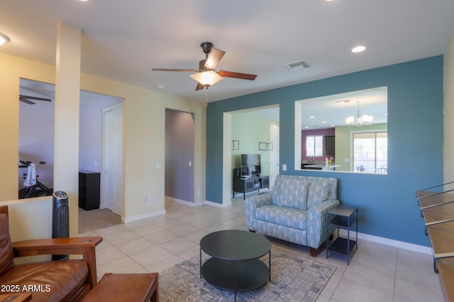 17743 N Rosa Dr, Maricopa, AZ 85138 - living room featuring light tile patterned flooring, visible vents, and ceiling fan with notable chandelier