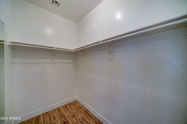 spacious closet featuring hardwood / wood-style flooring