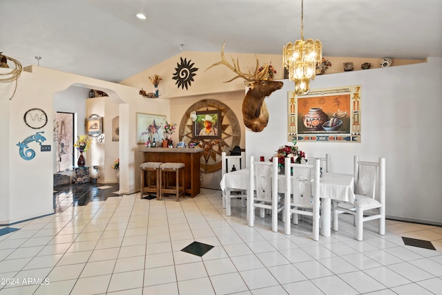 dining area with light tile patterned flooring, lofted ceiling, and an inviting chandelier