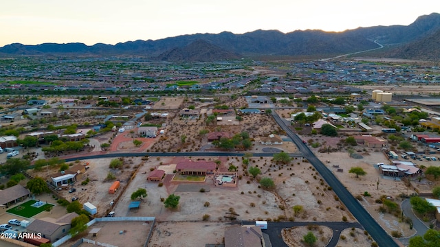 aerial view at dusk featuring a mountain view