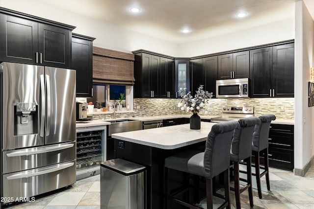6326 W Misty Willow Ln, Glendale, AZ 85310 - kitchen featuring stainless steel appliances, wine cooler, a sink, light countertops, and backsplash