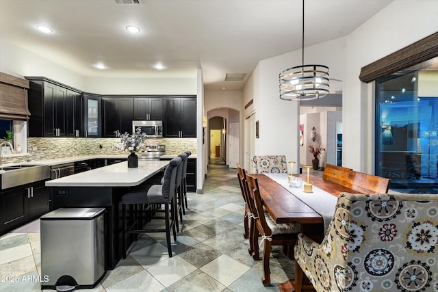 6326 W Misty Willow Ln, Glendale, AZ 85310 - dining room featuring arched walkways, a chandelier, and recessed lighting