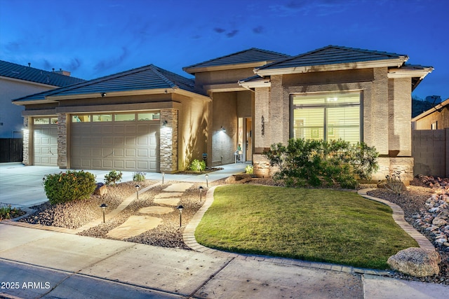 6326 W Misty Willow Ln, Glendale, AZ 85310 - view of front of home with an attached garage, concrete driveway, a tile roof, and stone siding