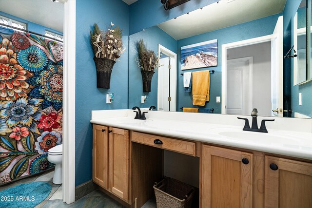 6326 W Misty Willow Ln, Glendale, AZ 85310 - full bath with double vanity, toilet, tile patterned floors, curtained shower, and a textured wall