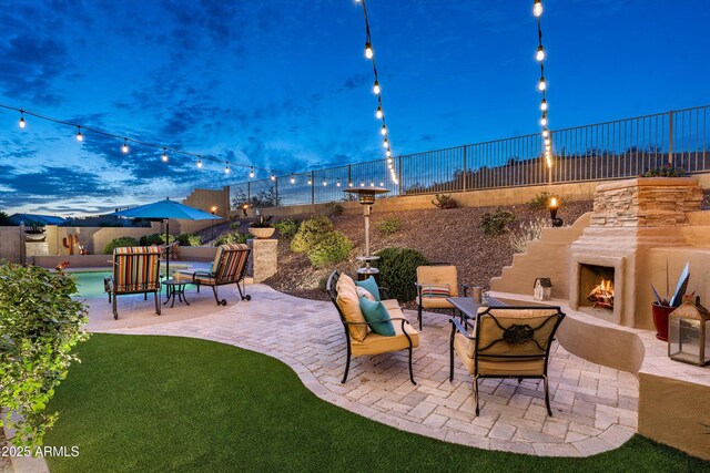 6326 W Misty Willow Ln, Glendale, AZ 85310 - fenced backyard featuring an outdoor stone fireplace and a patio