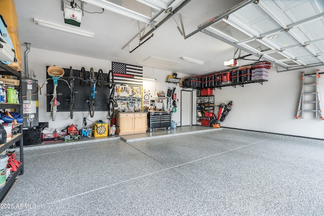 6326 W Misty Willow Ln, Glendale, AZ 85310 - garage featuring a garage door opener, gas water heater, and a workshop area