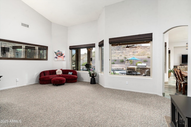 6326 W Misty Willow Ln, Glendale, AZ 85310 - sitting room featuring carpet flooring, high vaulted ceiling, arched walkways, baseboards, and ceiling fan