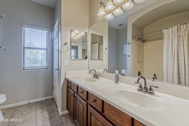 full bathroom featuring toilet, baseboards, a sink, and tile patterned floors