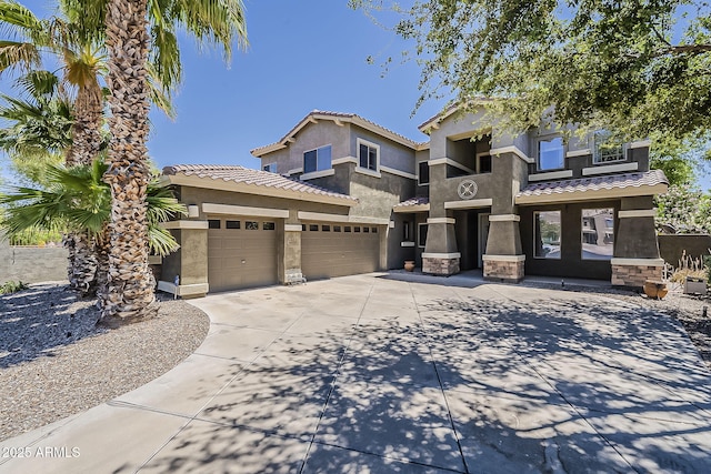 craftsman-style home with a tiled roof, concrete driveway, stucco siding, and stone siding