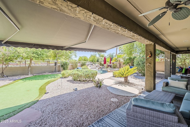 view of patio / terrace with a fenced backyard, a ceiling fan, and a fenced in pool