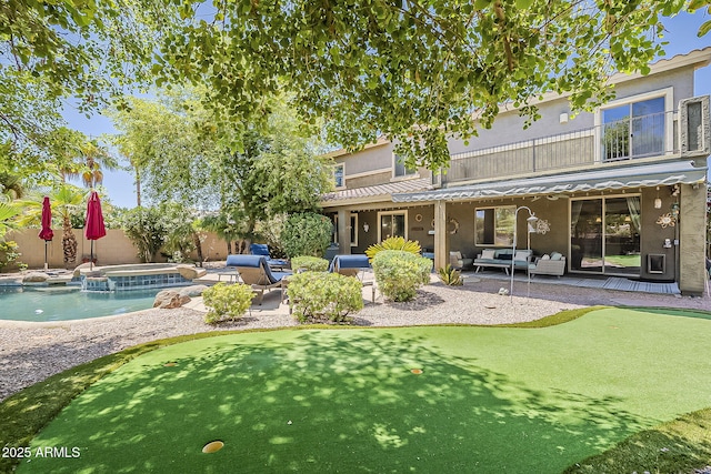 rear view of house featuring fence, an outdoor hangout area, stucco siding, a patio area, and a balcony
