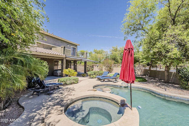 view of pool with a fenced backyard, a patio area, and a pool with connected hot tub