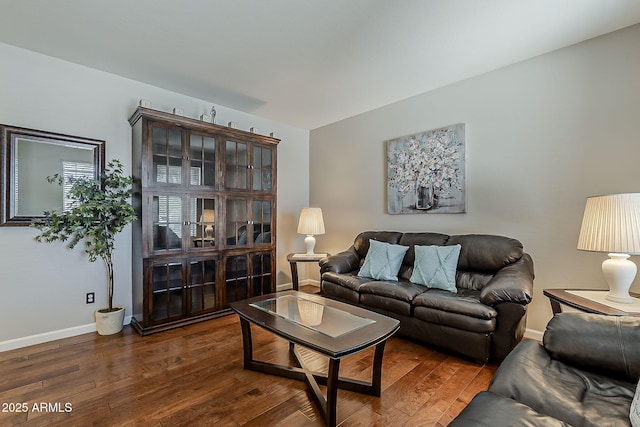 living area featuring baseboards and dark wood-style flooring
