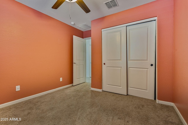 unfurnished bedroom featuring light carpet, a closet, and ceiling fan