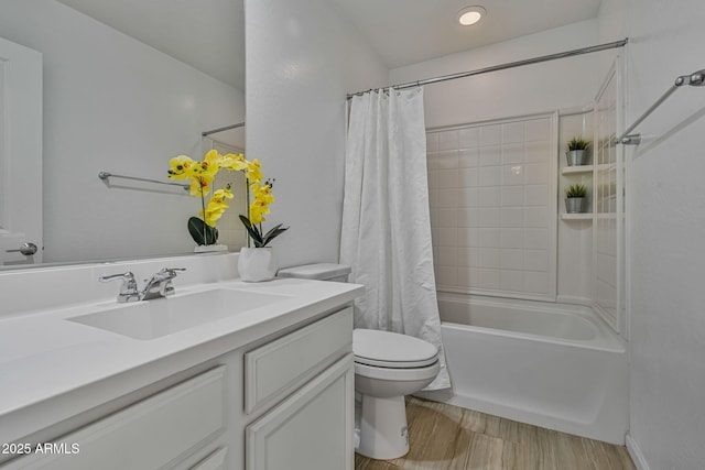 full bathroom featuring vanity, hardwood / wood-style floors, shower / tub combo with curtain, and toilet